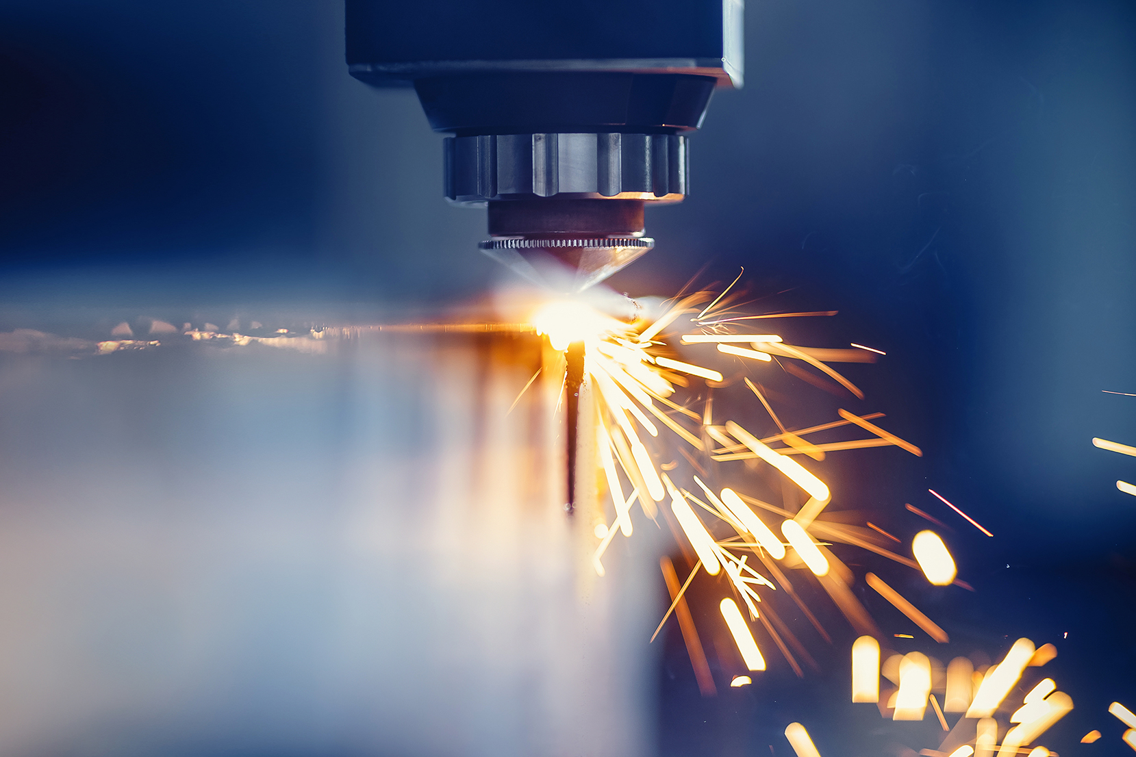 CNC gas cutting metal sheet, sparks fly. Blue steel color, modern industrial technology CNC gas cutting metal sheet, sparks fly. Blue steel color, modern industrial technology.
